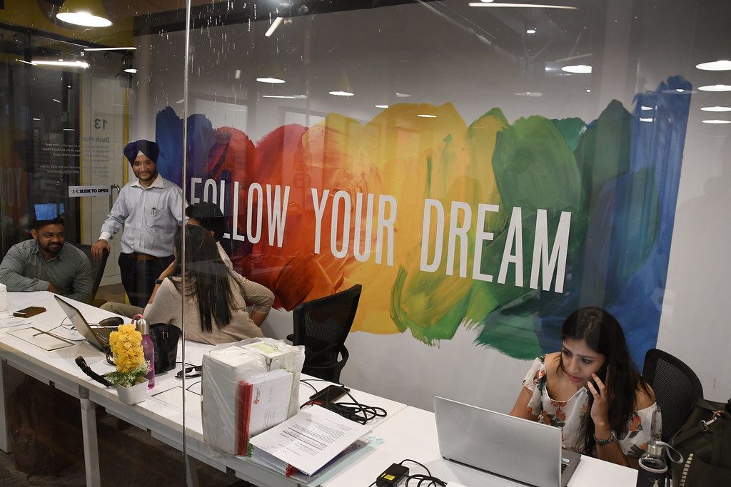 "General shots of working professionals in a co-working space in Delhi" by ILO in Asia and the Pacific is licensed under CC BY-NC-ND 2.0