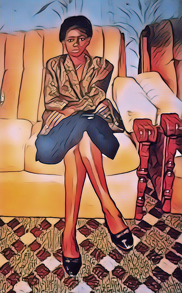 Image portrait of Farisai sitting on a sofa looking directly at the camera.
